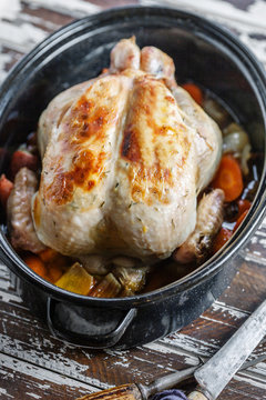 Thyme and lemon butter roasted chicken in roasting tin.