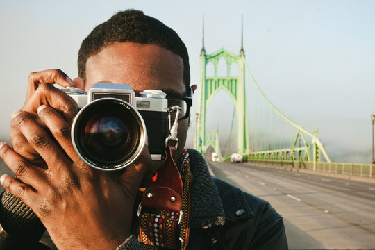 Man taking picture with a vintage film camera