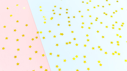Golden star sprinkles on double pink and blue. Festive holiday background. Celebration concept