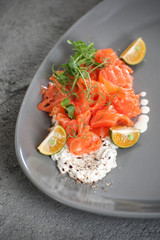 Salad from slightly salted salmon with cottage cheese cream and limequat..