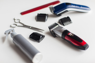 styling hair sprays, clippers, comb and scissors