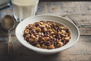 cornflakes in a white plate on a wooden table