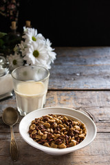 cornflakes in a white plate on a wooden table