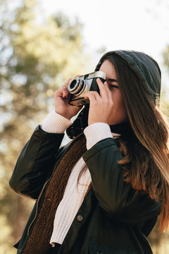 Young Woman Using a Retro Camera