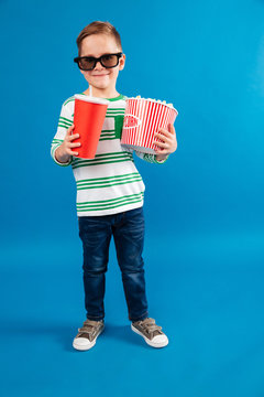 Full length image of Smiling young boy in eyeglasses