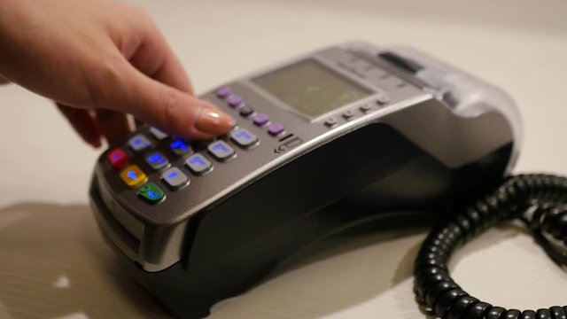 The girl is a cashier, she is paying by bank card with a card and a magnetic tape. 1920x1080, slow motion