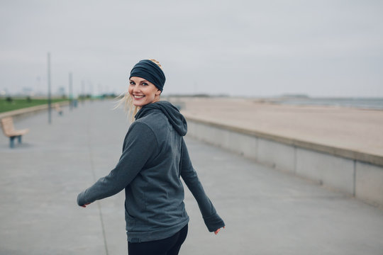 Portrait of a beautiful woman walking on the sea front in morning
