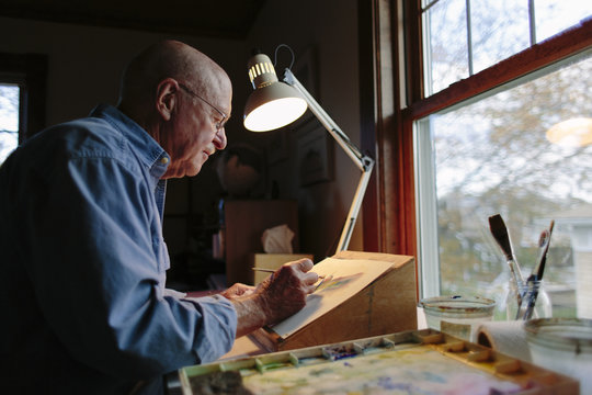 Senior Man Painting in Home Studio