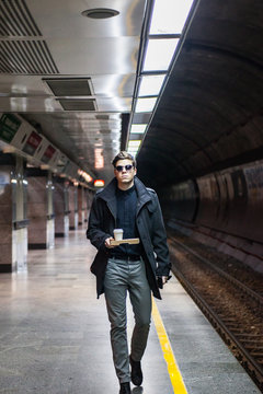 Man walking on train platform.