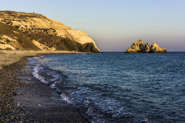 Fototapeta na wymiar Last rays of sunset in the Bay of Aphrodite