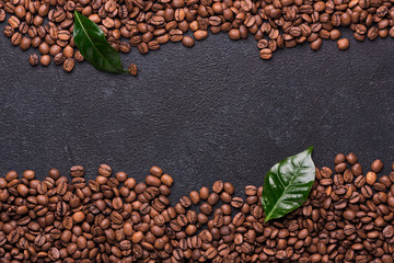 Coffe beans with coffe leaves on black background