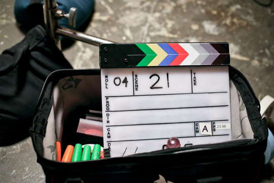 Clapboard sitting in a tool bag on a film set