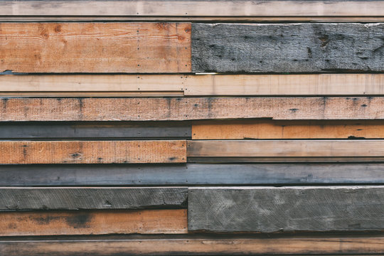 Various types of recycled wood paneling on wall of building exterior