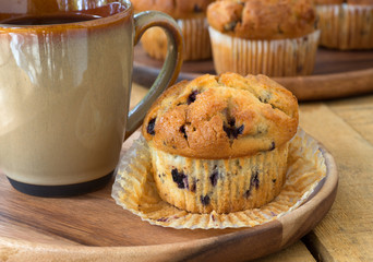 Blueberry Muffin and Coffee on a Wooden Plate