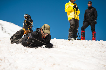 Learning to slip properly on a slope or glacier with an ice ax