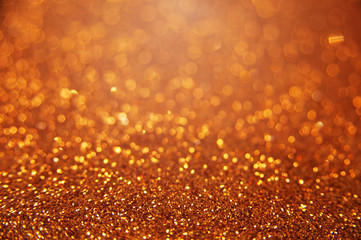 Golden bright glitter bokeh background. Sparkle texture for birthday card or christmas, new year, valentine's day, party and other holidays invitation.