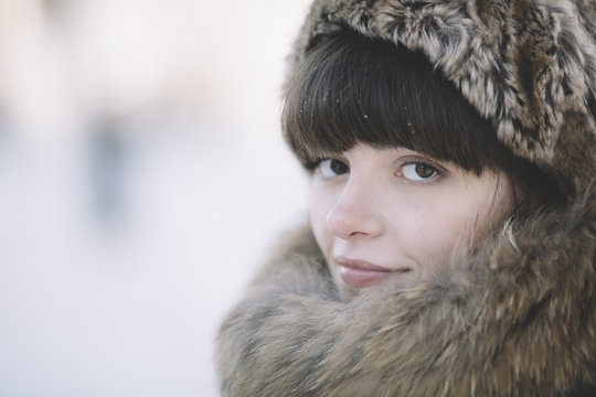 winter close-up of the young woman with fur hat