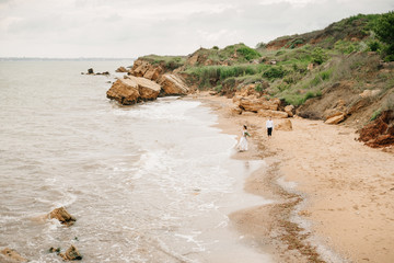 young couple groom with the bride on a sandy beach