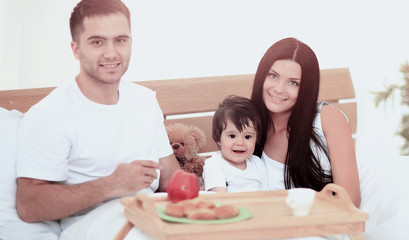 Obraz na płótnie Canvas Smiling family having breakfast