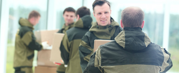 Fototapeta premium workers unload boxes
