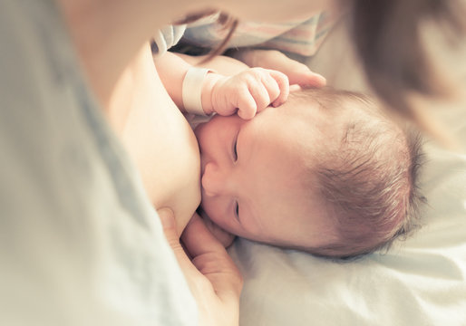 New born baby boy breastfeeding. 