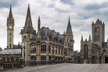 Fototapeta na wymiar View from Sint-Michielsplein (St Michael's Bridge) at Clock tower, Old post office and Saint-Nicholas Church in Ghent, Belgium. Medieval buildings and towers