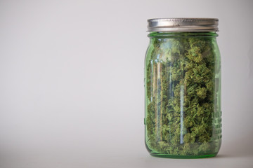 White background jar of medical marijuana