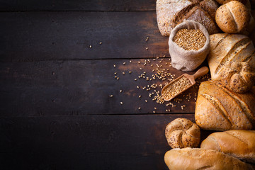 Bread on wooden table, top view.