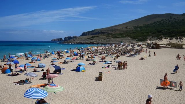Cala Mesquida Mallorca Spain: Tourists sunbathing on the beach