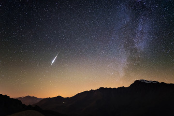 Milky Way and starry sky from high up on the Alps. Real Christmas comet in the sky. Majestic high mountain range with glacier and snow. - obrazy, fototapety, plakaty