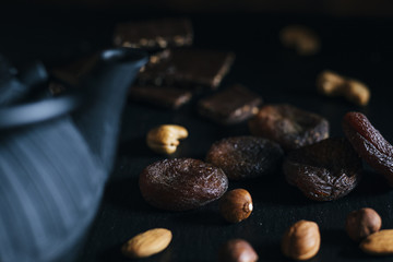 Variety of mixed nuts - almond, hazelnuts and cashew - on the dark slate background with copy space. Top view. Toned