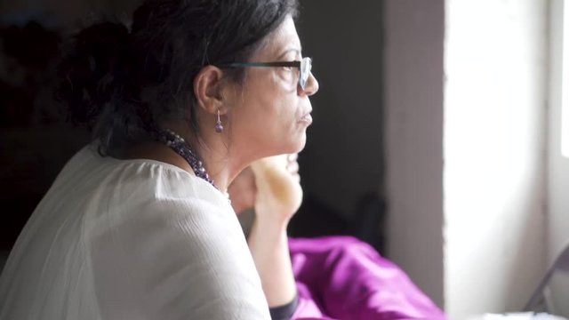 Polarity therapist holds her client&rsquo;s head, then the camera moves focus to the therapist holding her client&rsquo;s foot, directing the energy and chakras.