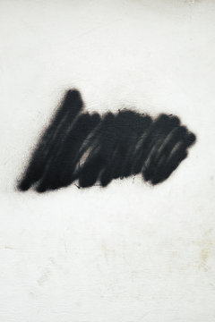Black spray paint on wall exterior