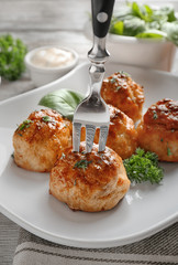 Fork with delicious meatball on plate