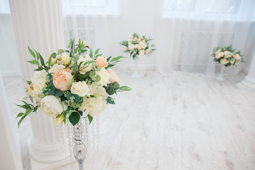 Artificial flowers. Vase with a flower arrangement in an expensive interior.