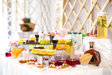 Table with desserts and drinks for wedding