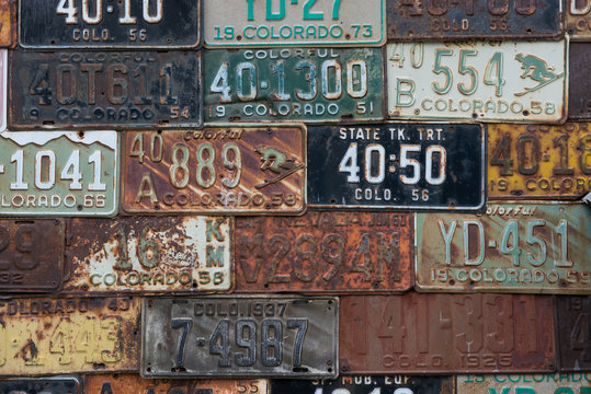 Fototapeta Vintage Colorado license plates mounted on an exterior wall