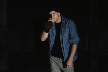 Man drinking alcohol on dark background