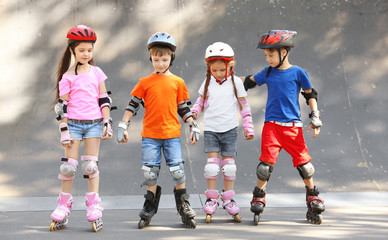 Cute children on rollers in skate park - obrazy, fototapety, plakaty