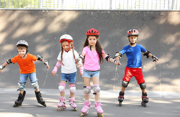Active children rollerblading in skate park - obrazy, fototapety, plakaty
