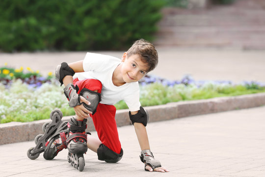 Cute boy on roller skates in park