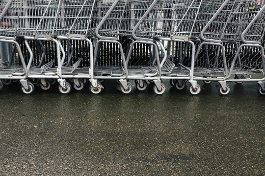 Row of metal grocery carts outside store