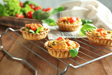 Delicious crispy tarts with broccoli on cooling rack