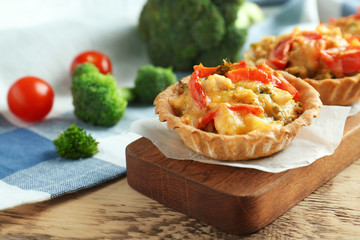 Delicious crispy tart with broccoli on wooden board