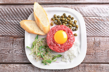 Delicious steak tartare with yolk on plate