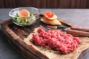 Delicious steak tartare on wooden board