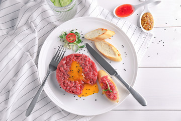 Delicious steak tartare with yolk on plate