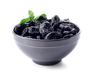 Bowl with tasty dried plums on white background