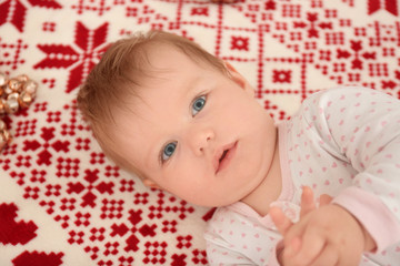 Adorable baby lying on bed at home