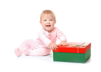 Adorable baby with Christmas gift box on white background